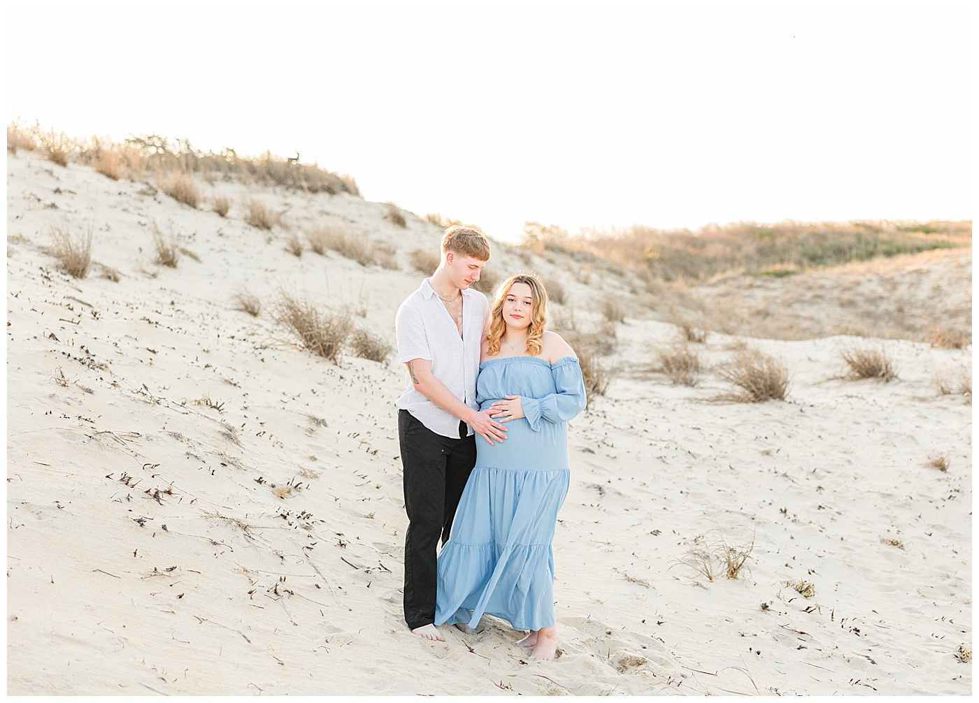 Virginia Beach maternity photographer capturing couple at Back Bay Wildlife Refuge during sunset