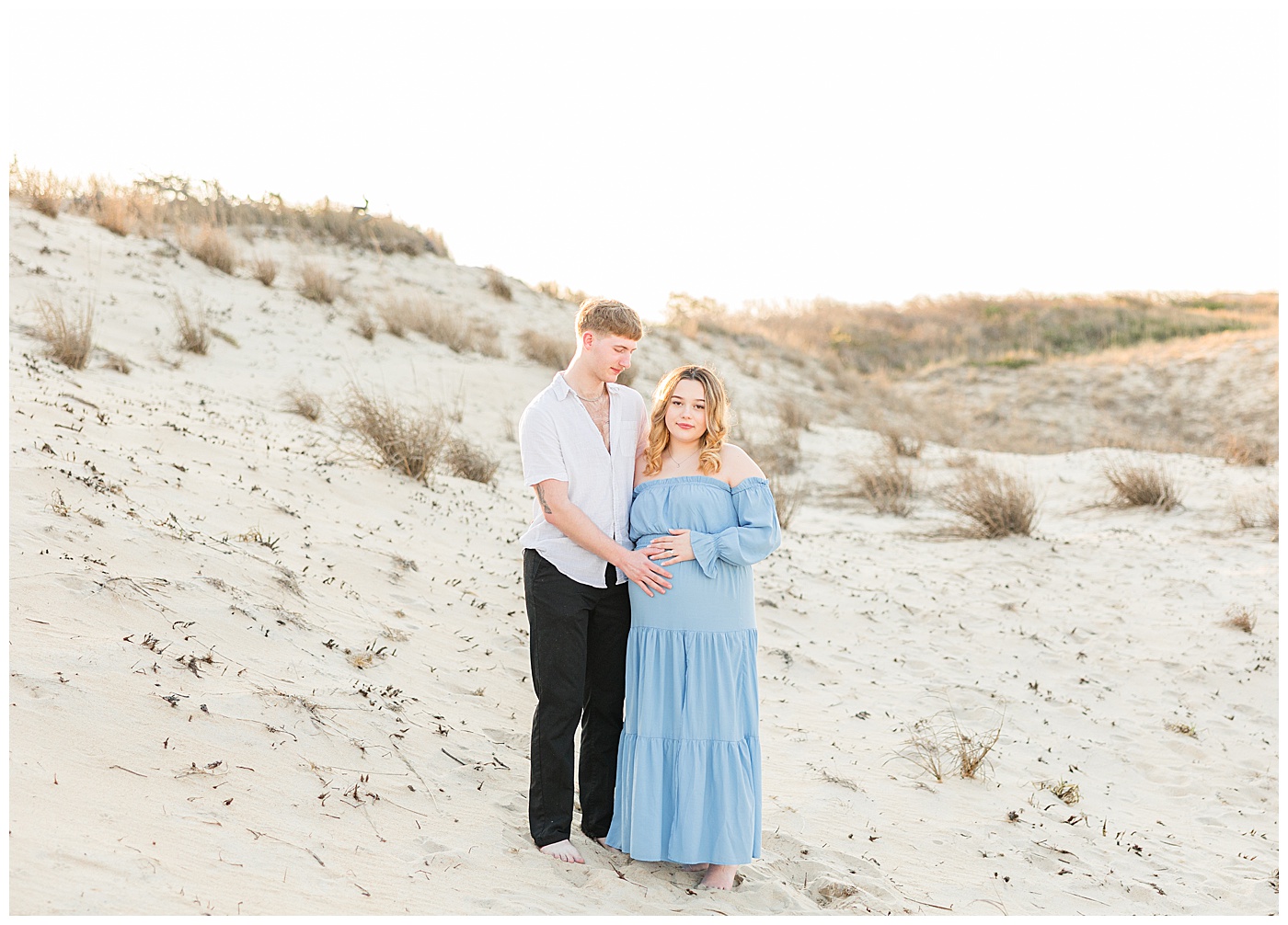 Virginia Beach maternity photographer capturing couple at Back Bay Wildlife Refuge during sunset