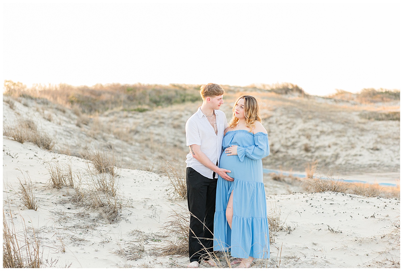 Virginia Beach maternity photographer capturing couple at Back Bay Wildlife Refuge during sunset